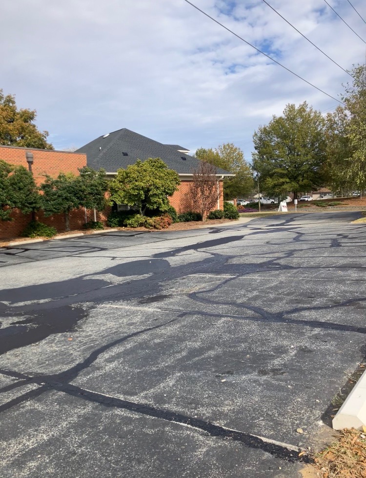 Faded parking lot before professional striping in Greensboro NC
