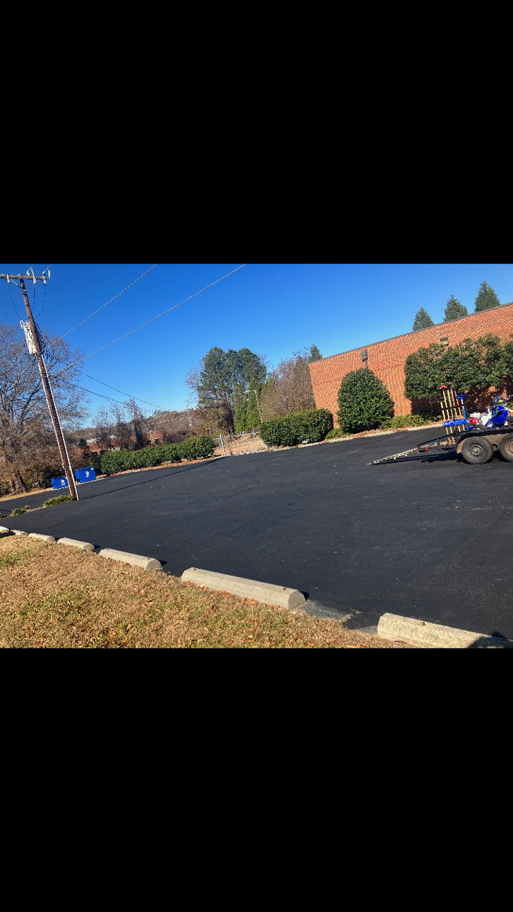 Worn parking lot lines before restriping in Greensboro NC